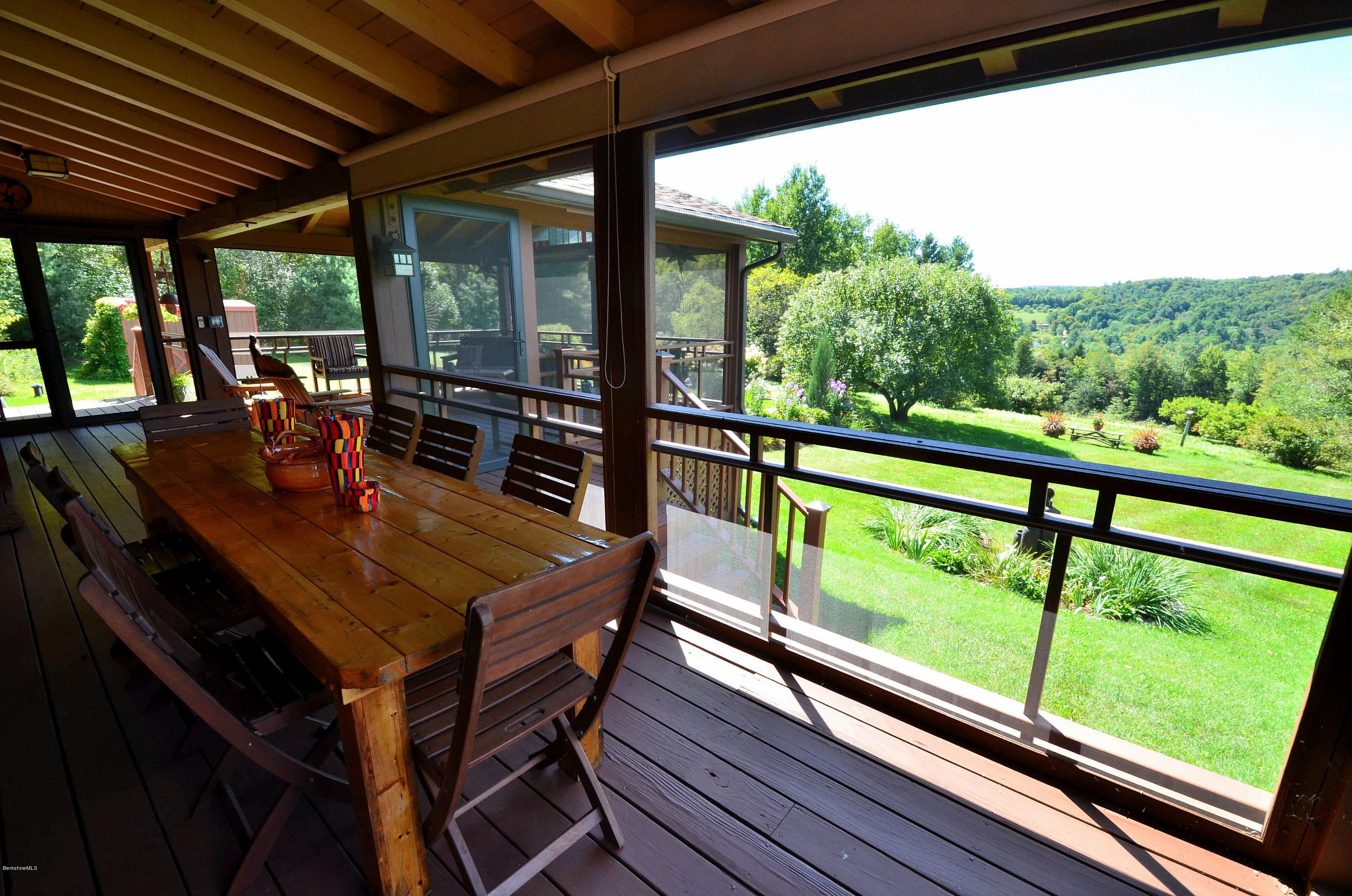 286 Johnson Hill Road Washington, MA 01223 - Photo 6 of 30 a view of a patio with table and chairs and wooden floor