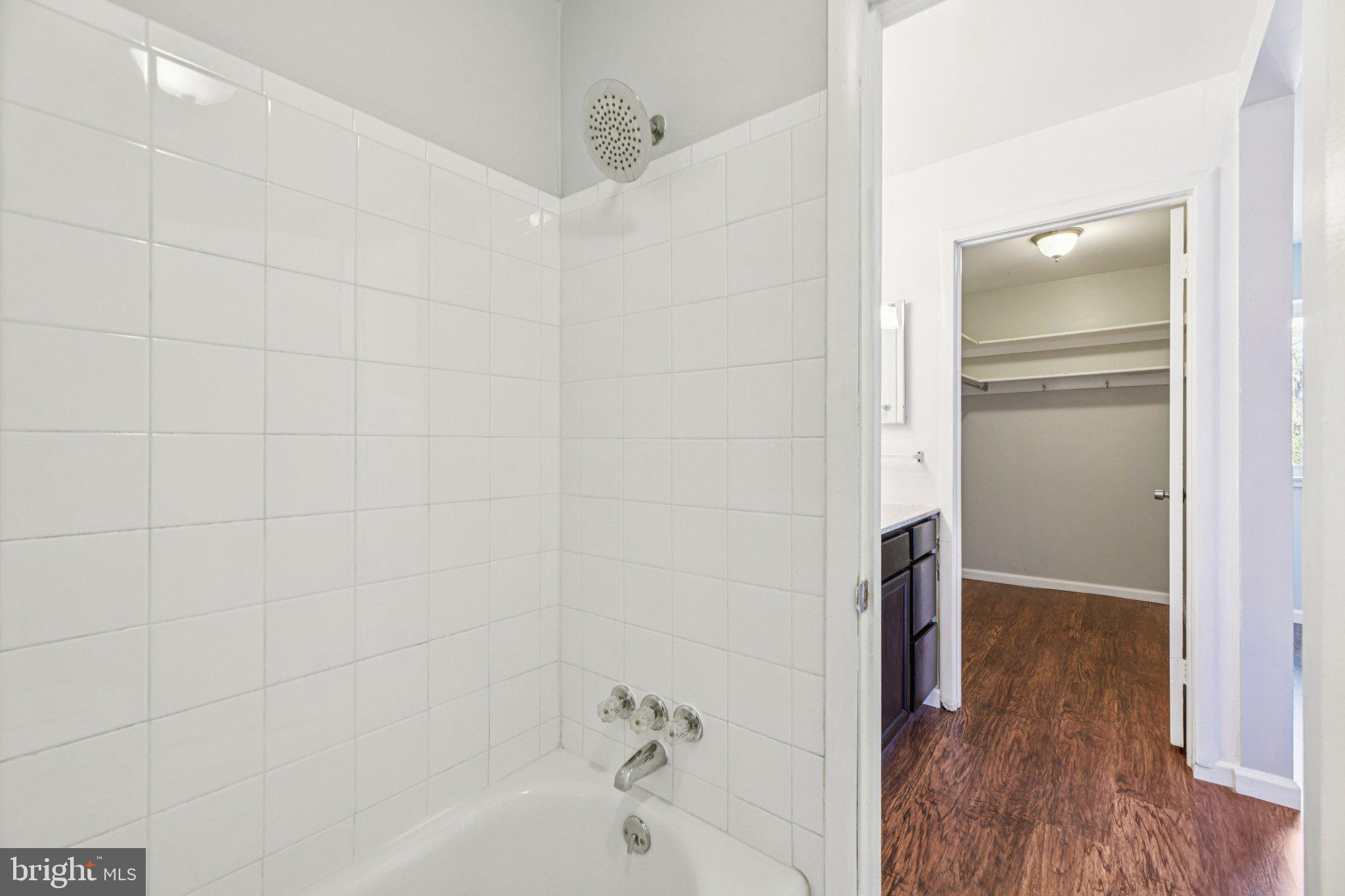 10216 Prince Place, Unit 9202 Upper Marlboro, MD 20774 - Photo 14 of 32 a bathroom with a bathtub and a shower