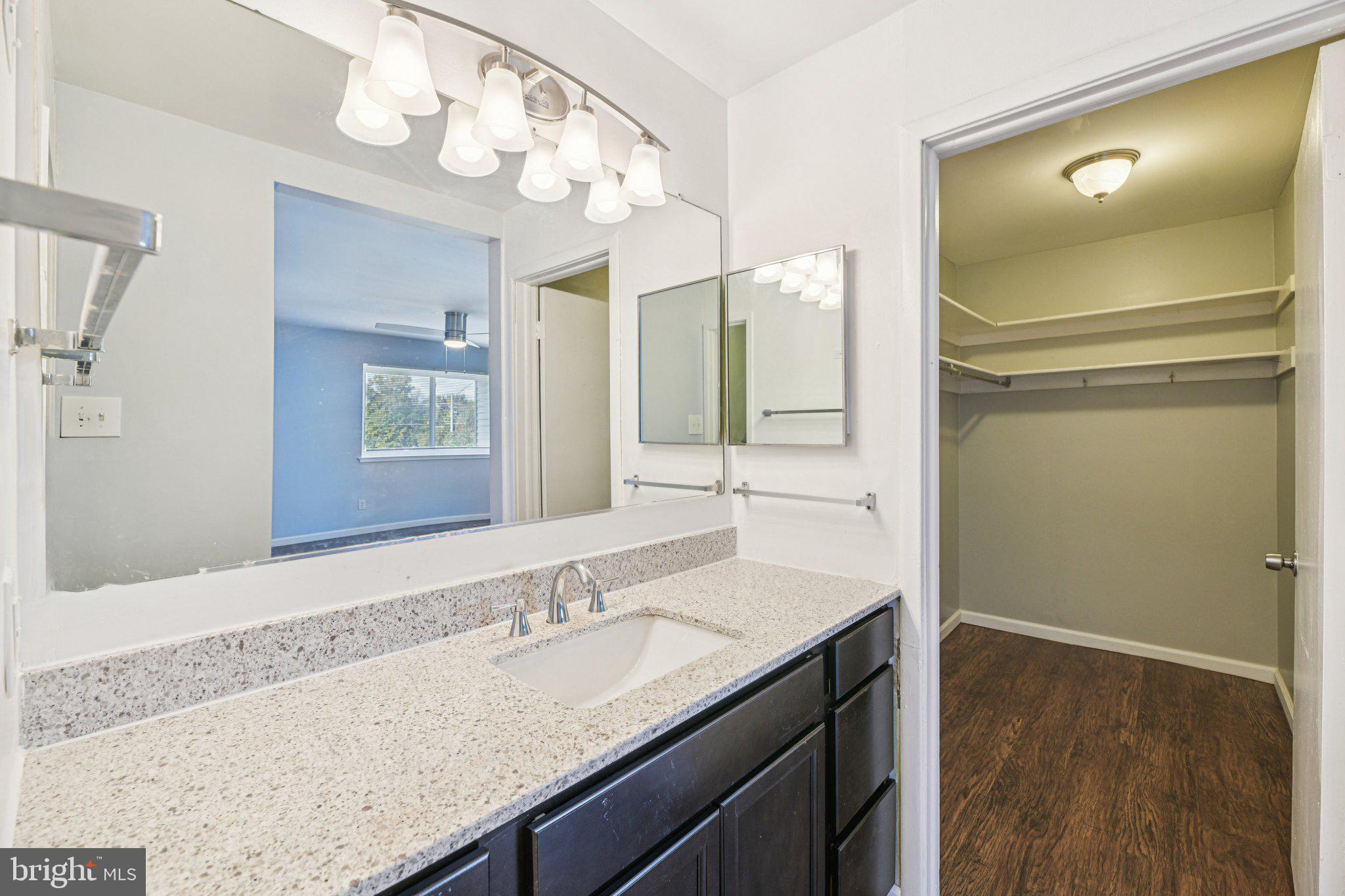 10216 Prince Place, Unit 9202 Upper Marlboro, MD 20774 - Photo 16 of 32 a bathroom with a granite countertop sink and a mirror