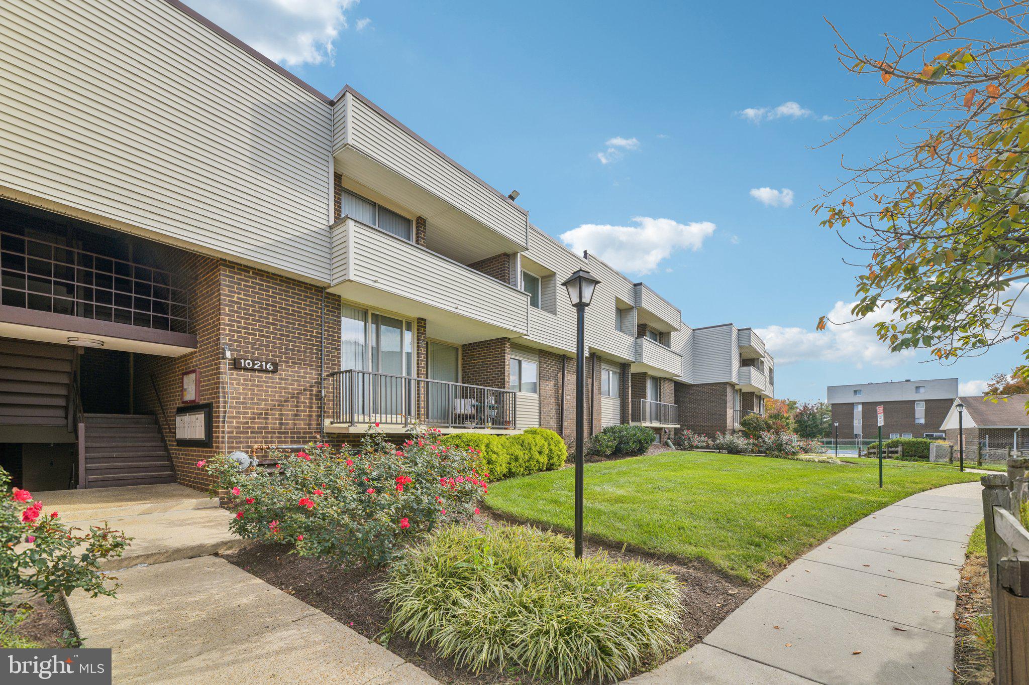 10216 Prince Place, Unit 9202 Upper Marlboro, MD 20774 - Photo 2 of 32 a front view of a house with garden
