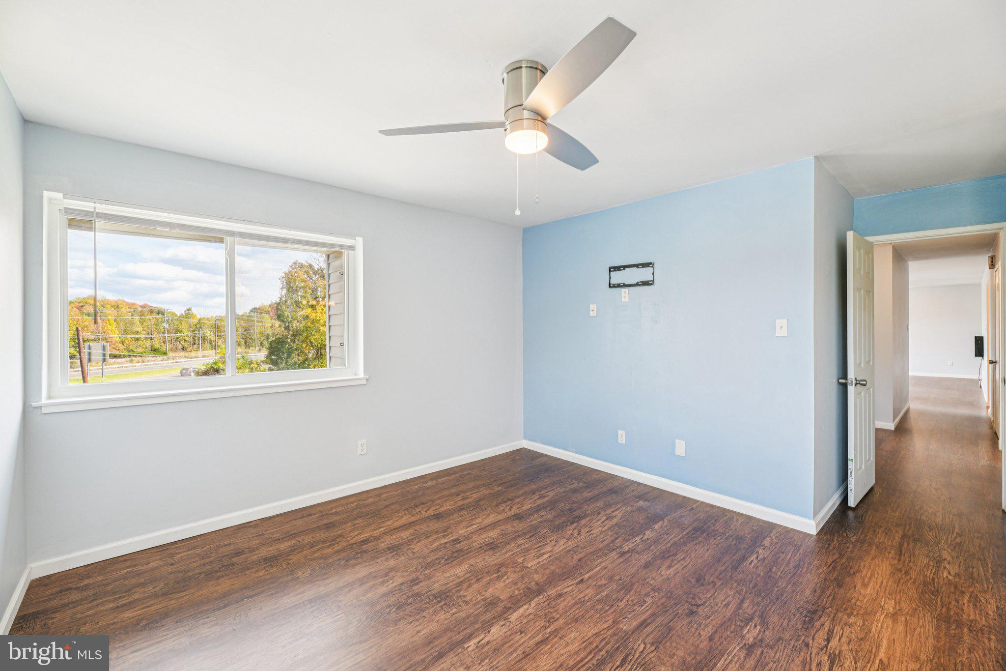10216 Prince Place, Unit 9202 Upper Marlboro, MD 20774 - Photo 21 of 32 wooden floor in an empty room with a window
