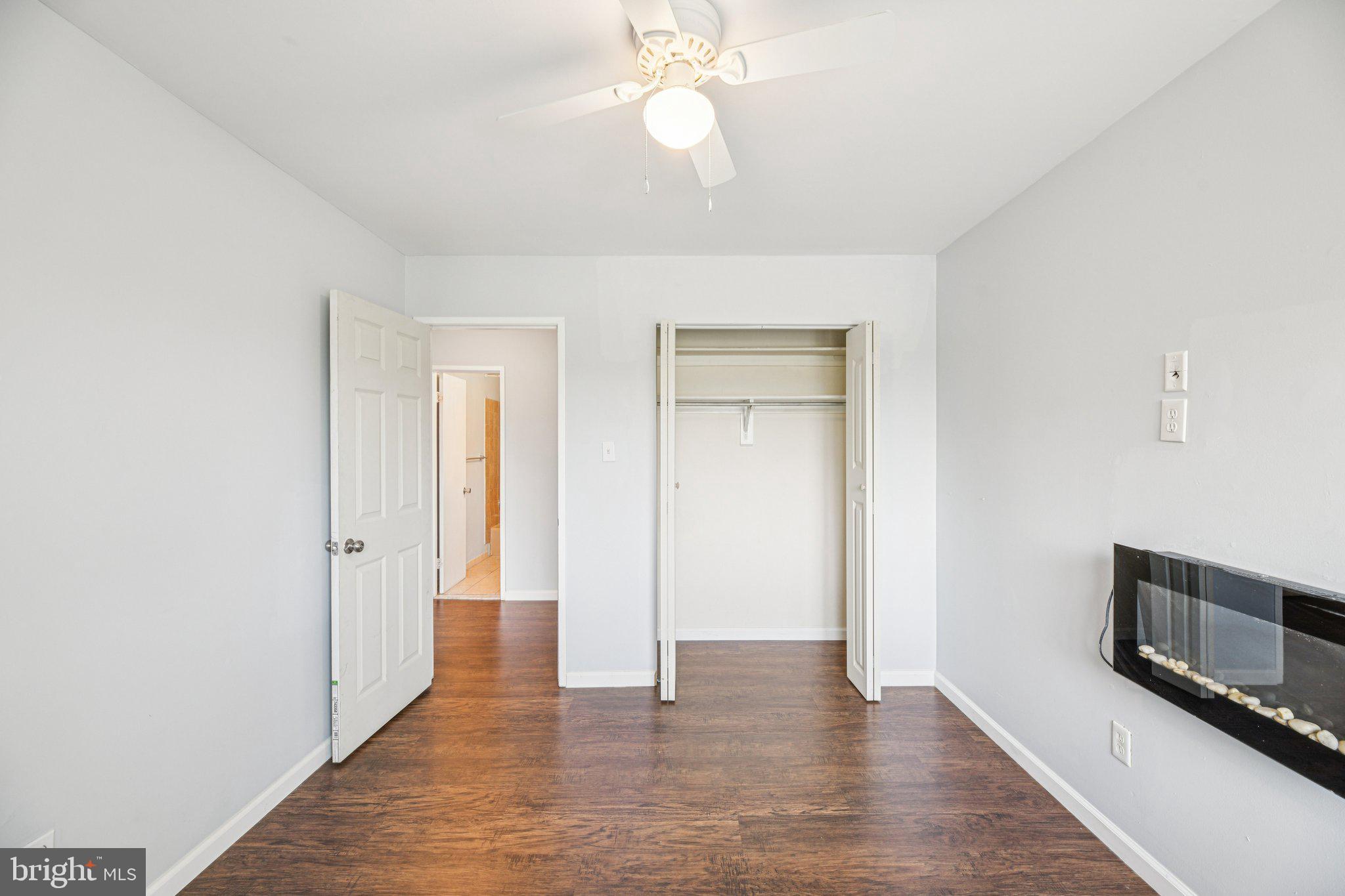 10216 Prince Place, Unit 9202 Upper Marlboro, MD 20774 - Photo 25 of 32 wooden floor in an empty room with a chandelier fan