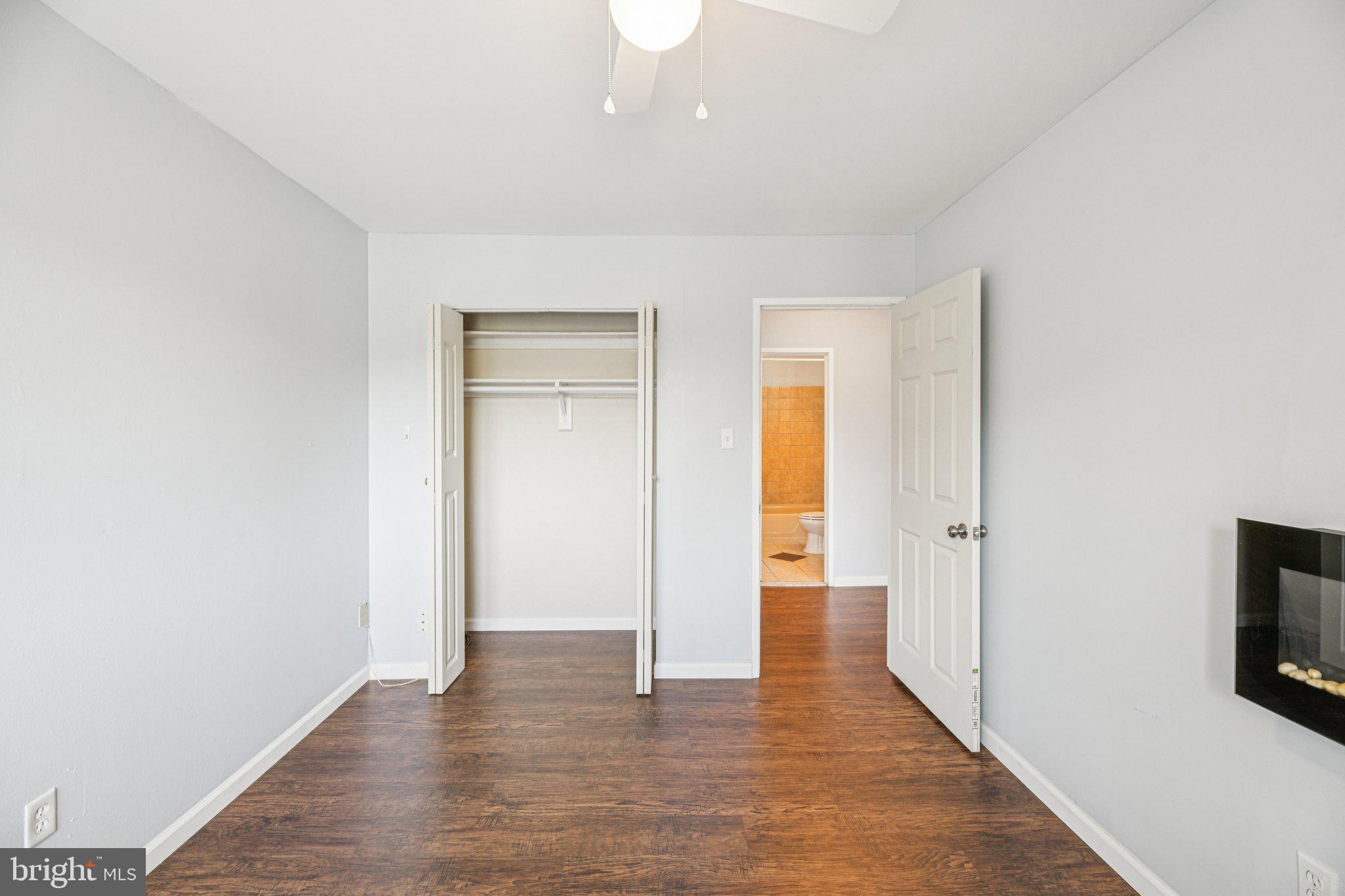 10216 Prince Place, Unit 9202 Upper Marlboro, MD 20774 - Photo 28 of 32 a view of an empty room with wooden floor and a window