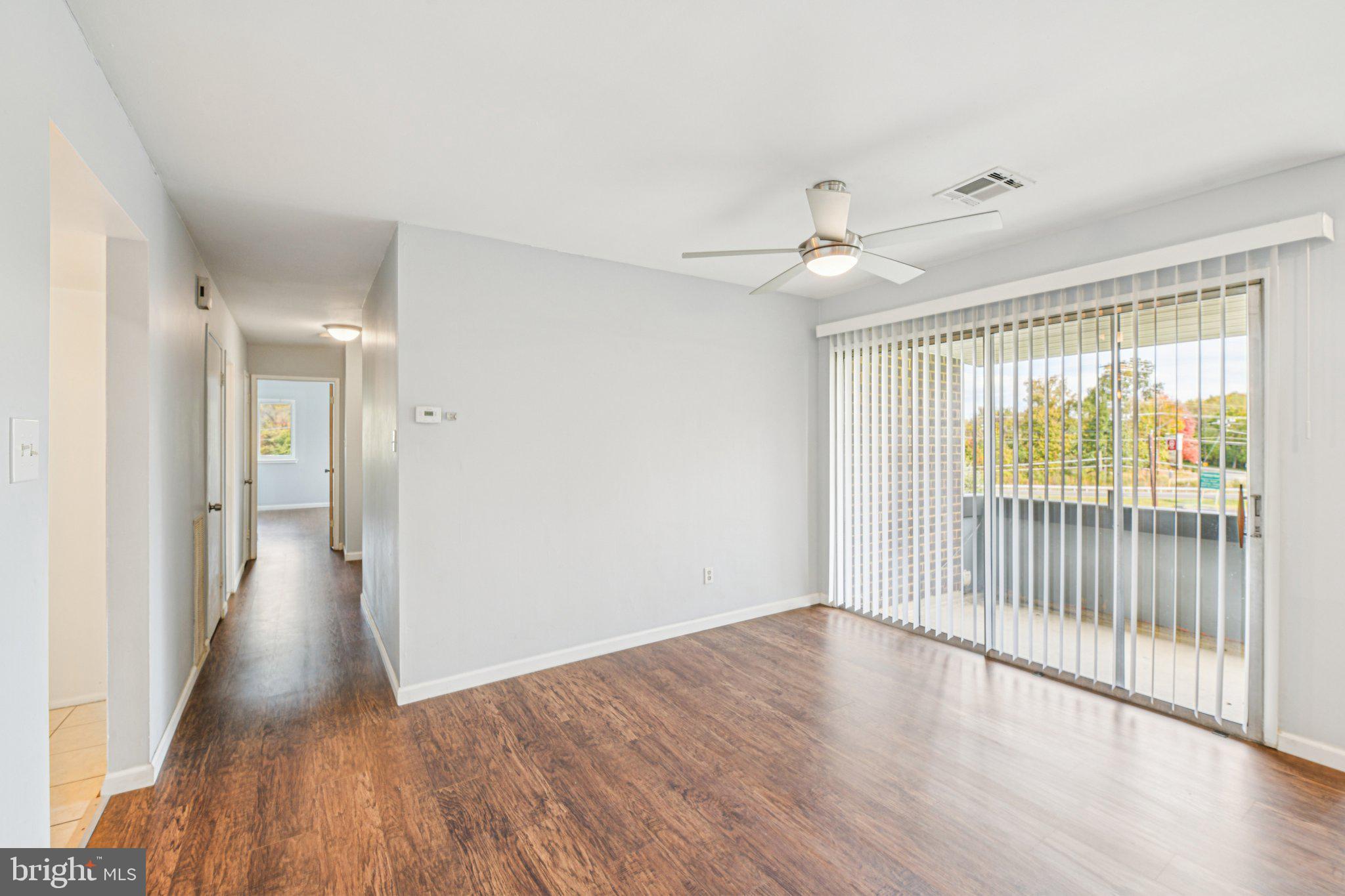 10216 Prince Place, Unit 9202 Upper Marlboro, MD 20774 - Photo 4 of 32 a view of a hallway with wooden floor and a chandelier