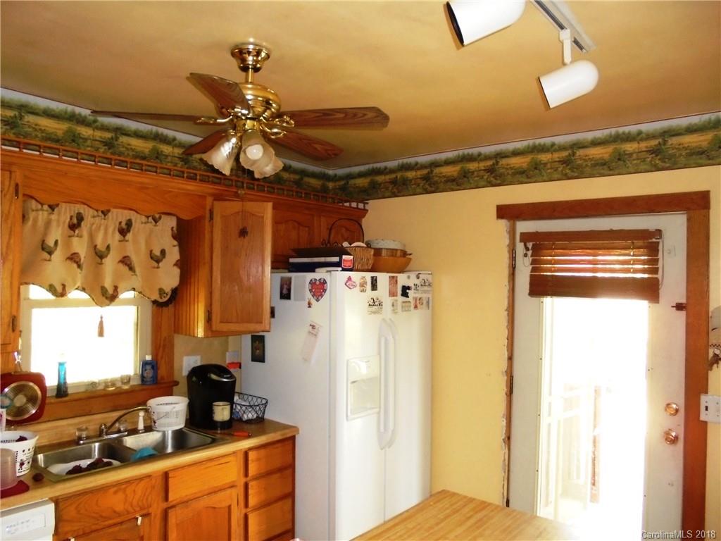 108 Howell Road Marshall, NC 28753 - Photo 23 of 26 a bedroom with a bed and cabinets
