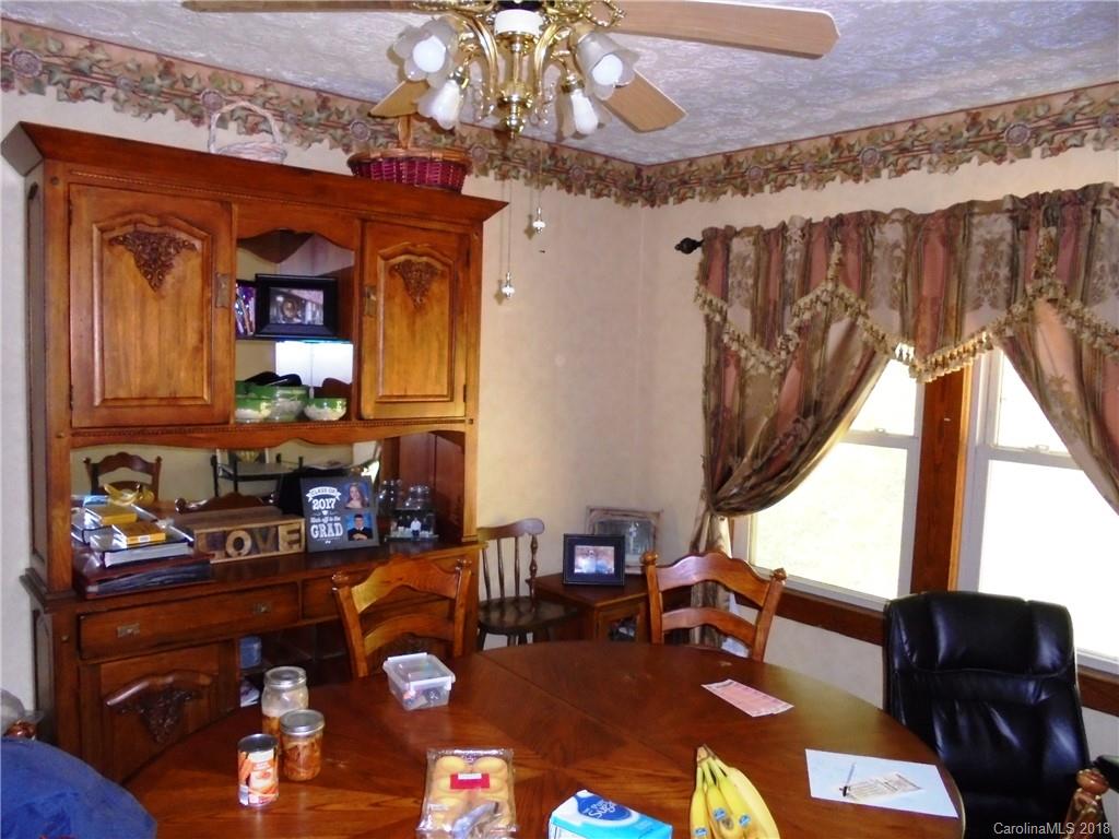108 Howell Road Marshall, NC 28753 - Photo 24 of 26 a living room with furniture a chandelier and a fireplace