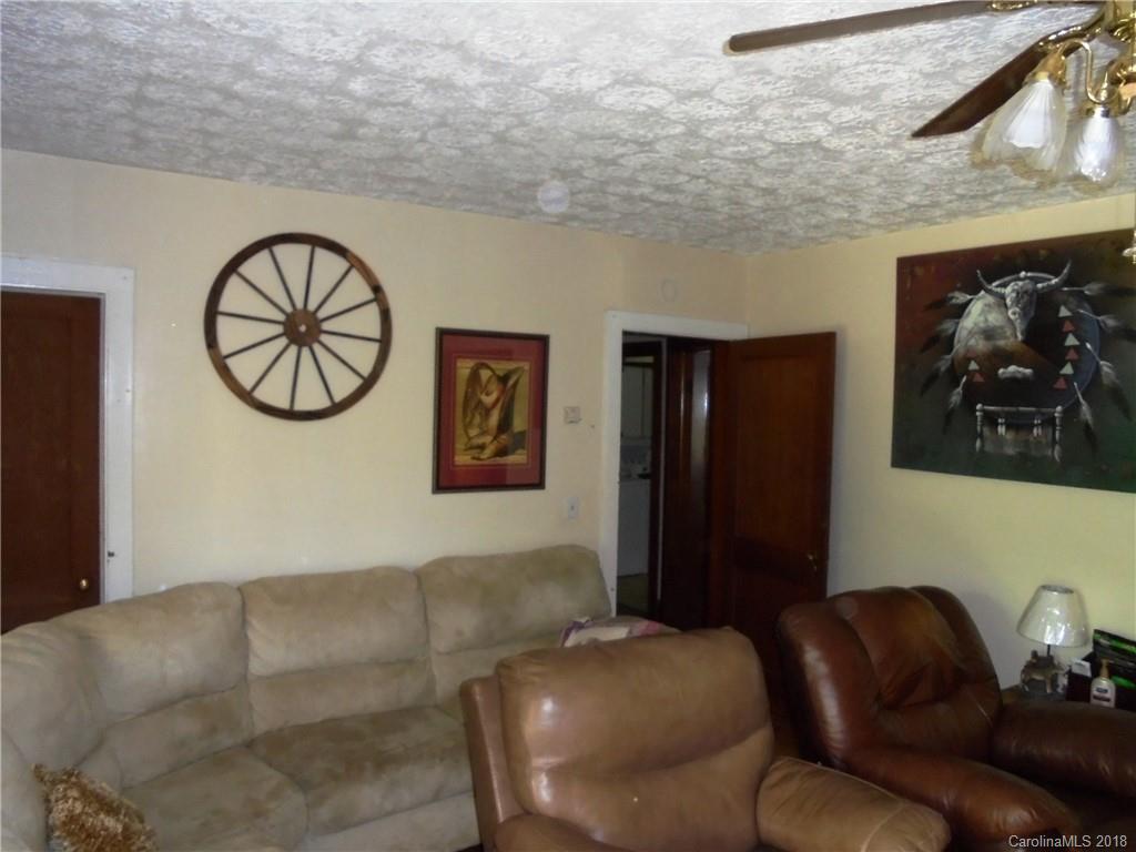 108 Howell Road Marshall, NC 28753 - Photo 26 of 26 a living room with furniture and a wall painting