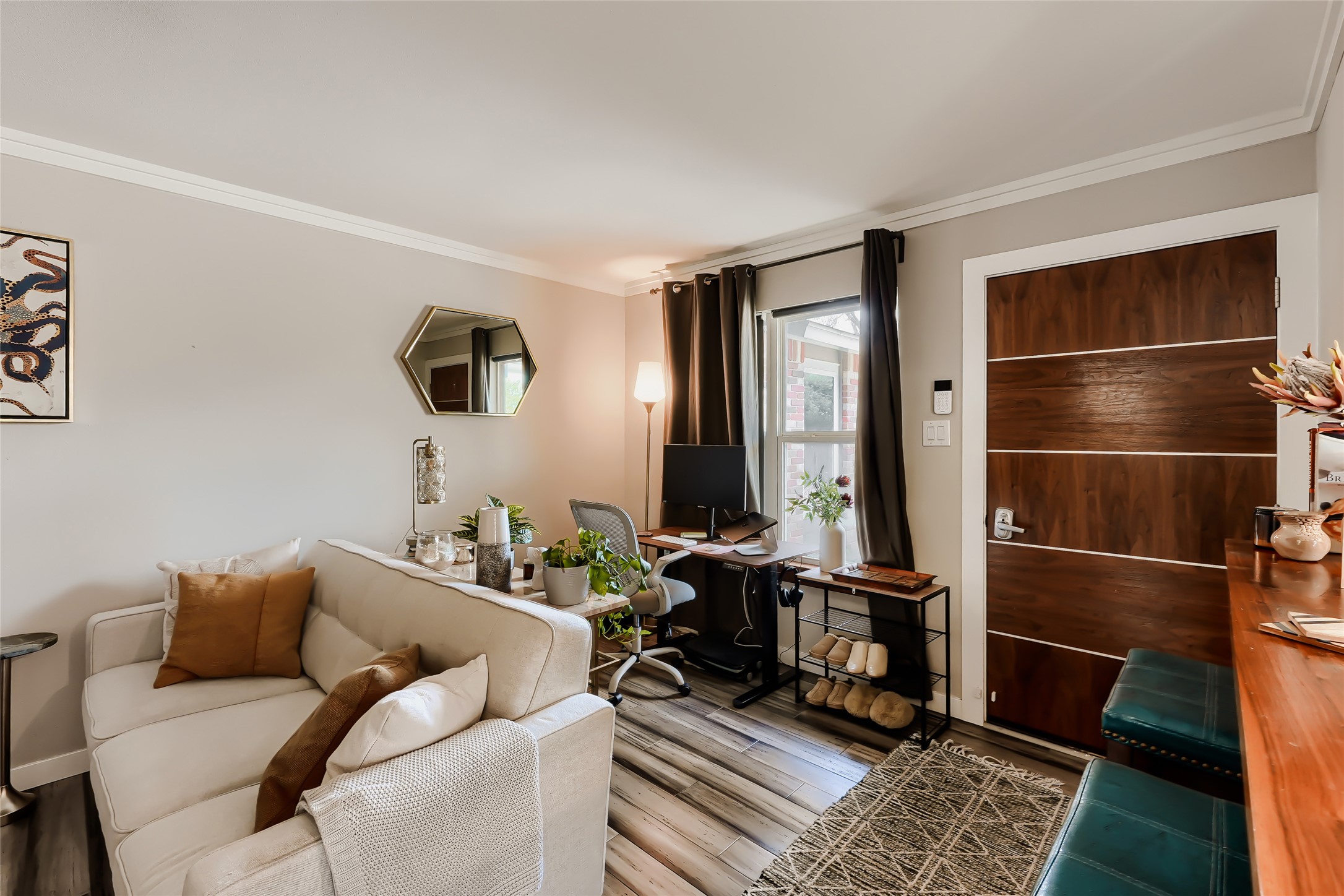 5707 Tracy Lynn Lane, Unit A Austin, TX 78721 - Photo 11 of 33 Living area featuring ornamental molding, light wood-style floors, and a desk