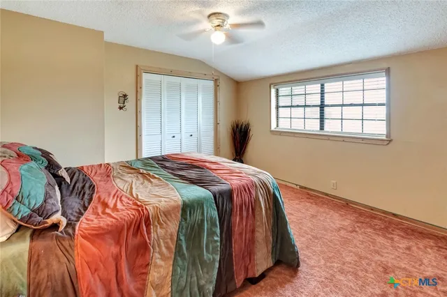 a bedroom with a bed and closet