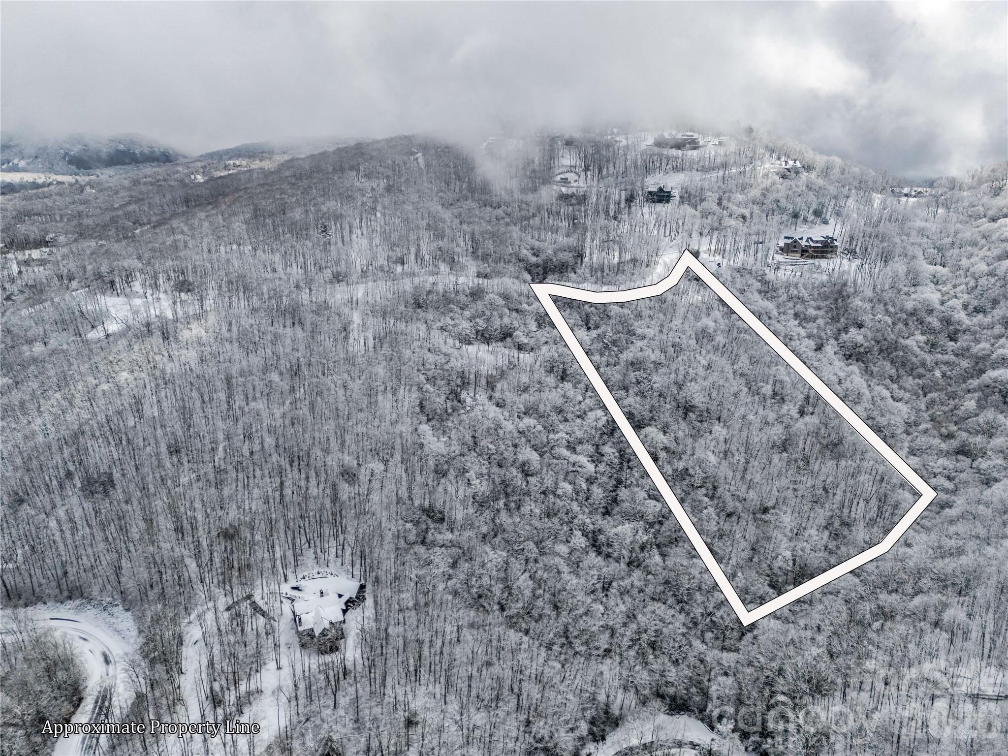 D54 Springwater Road, Unit D54 Glenville, NC 28736 - Photo 3 of 26 a view of a dry yard with mountain view