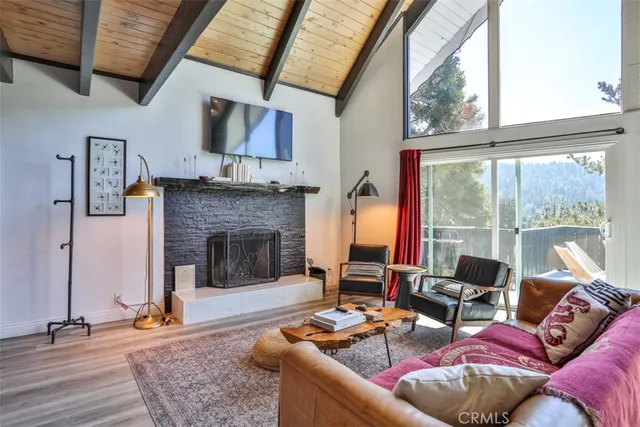 a kitchen with granite countertop a stove a sink and a wooden floors