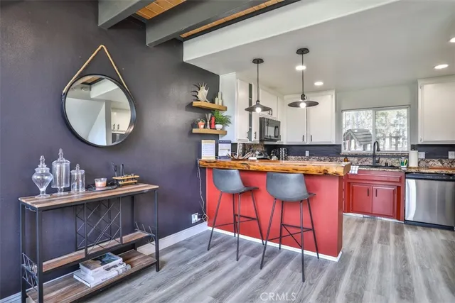a kitchen with stainless steel appliances granite countertop a refrigerator and a stove top oven