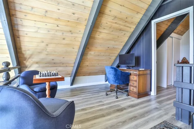 a bedroom with a bed and a flat tv screen on dresser
