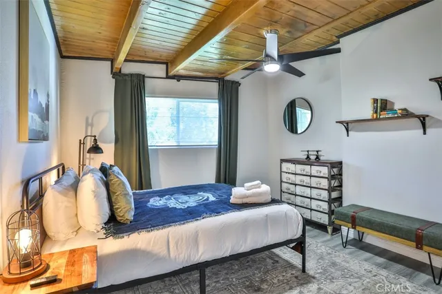 a view of a chair and tables under an umbrella