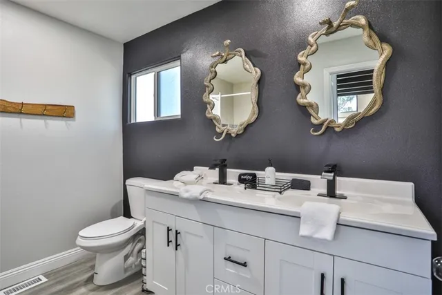a bathroom with a toilet sink and mirror