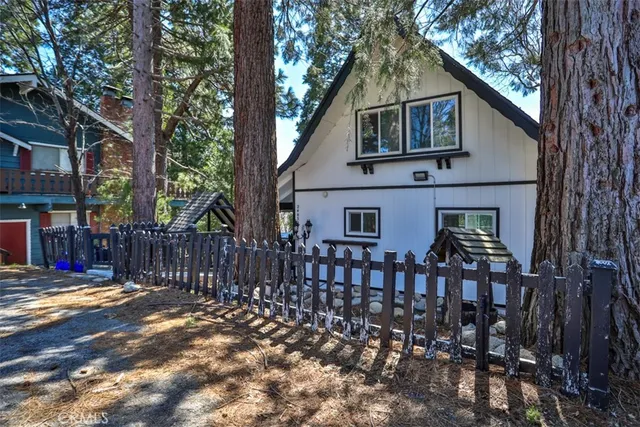 a front view of house with yard outdoor seating and pathway