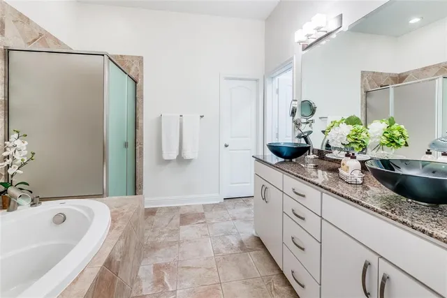 a bathroom with a granite countertop sink a toilet and shower