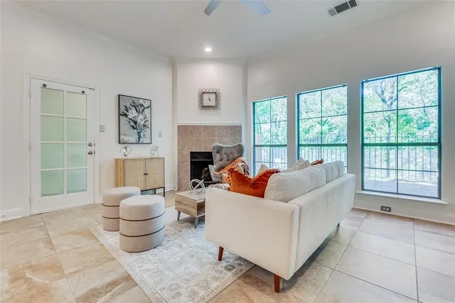 a living room with furniture and a floor to ceiling window