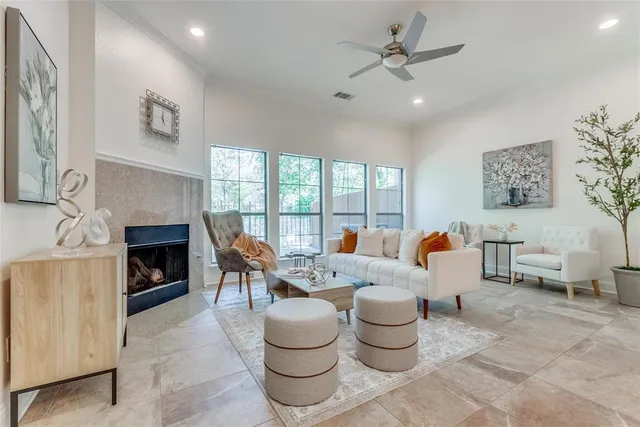 a living room with furniture a fireplace and a chandelier