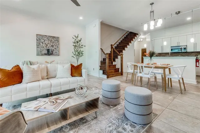 a living room with furniture and a chandelier