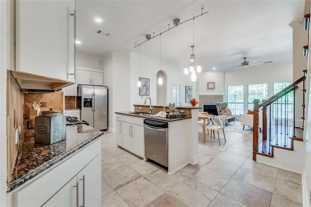 a kitchen with lots of counter top space and stainless steel appliances