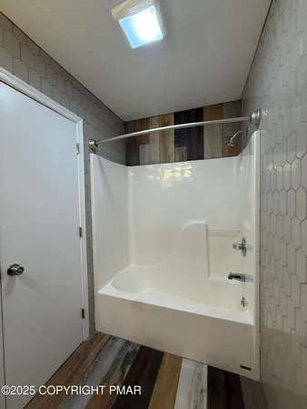 an empty room with window and ceiling fan