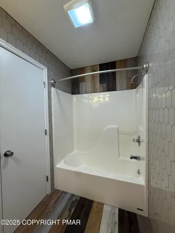 an empty room with window and ceiling fan