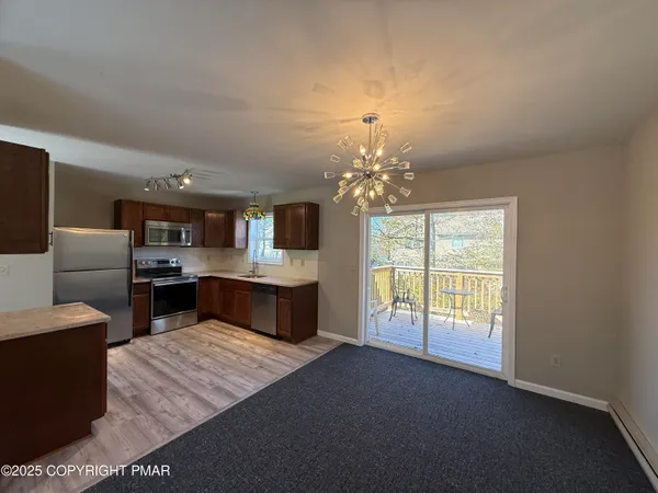 a large kitchen with stainless steel appliances granite countertop a large counter top and a stove