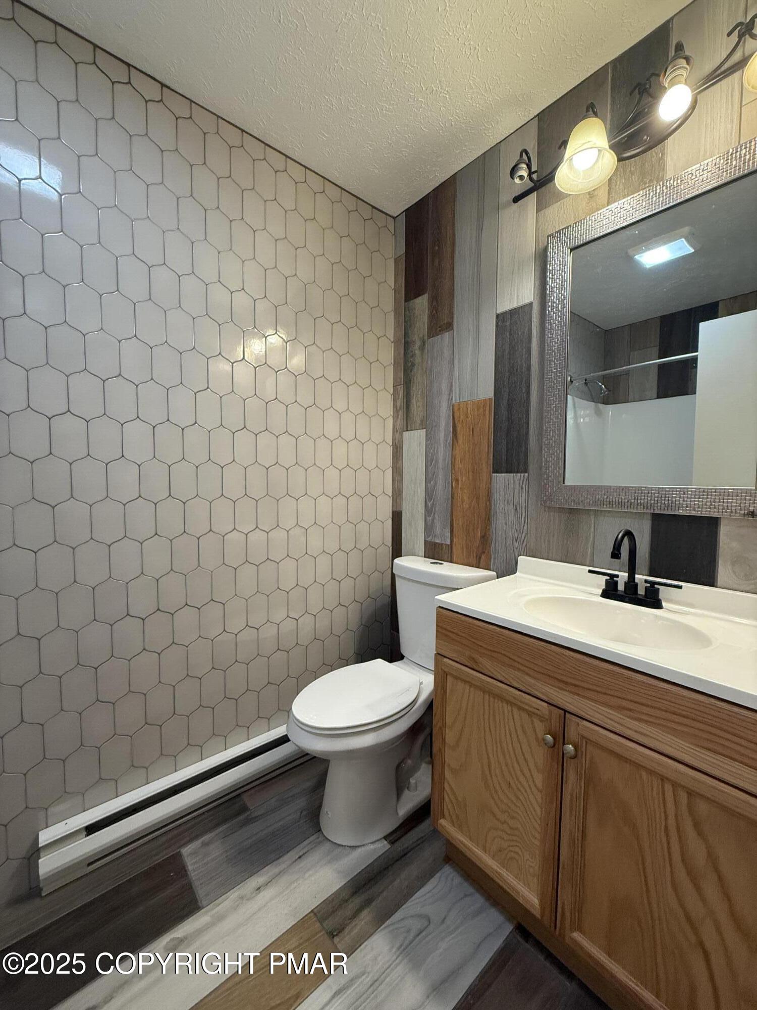 1753 Rolling Hills Drive Tobyhanna, PA 18466 - Photo 10 of 25 a bathroom with a sink toilet and a mirror