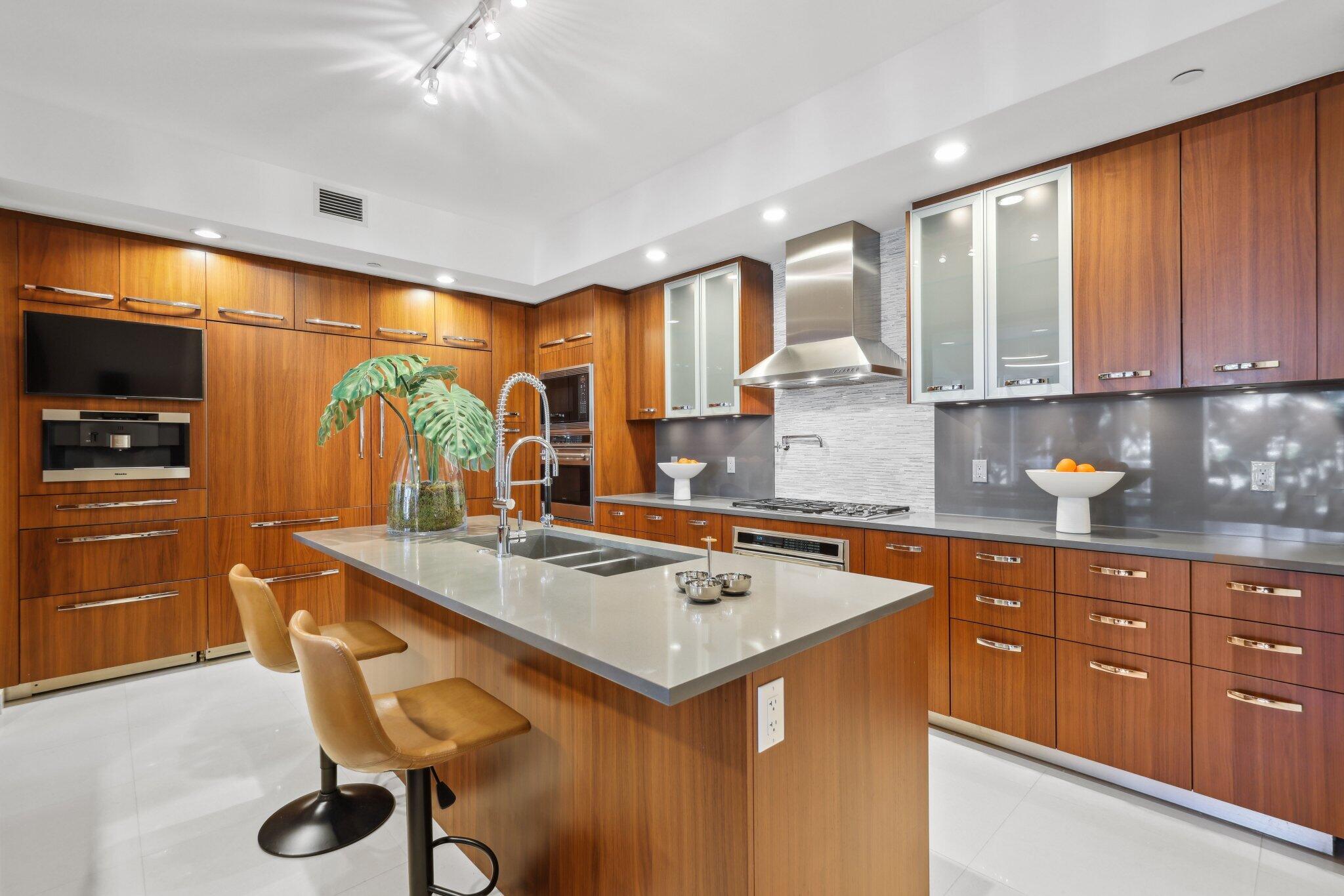 1000 South Ocean Boulevard, Unit 309 Boca Raton, FL 33432 - Photo 12 of 63 a kitchen with a stove a sink and a refrigerator