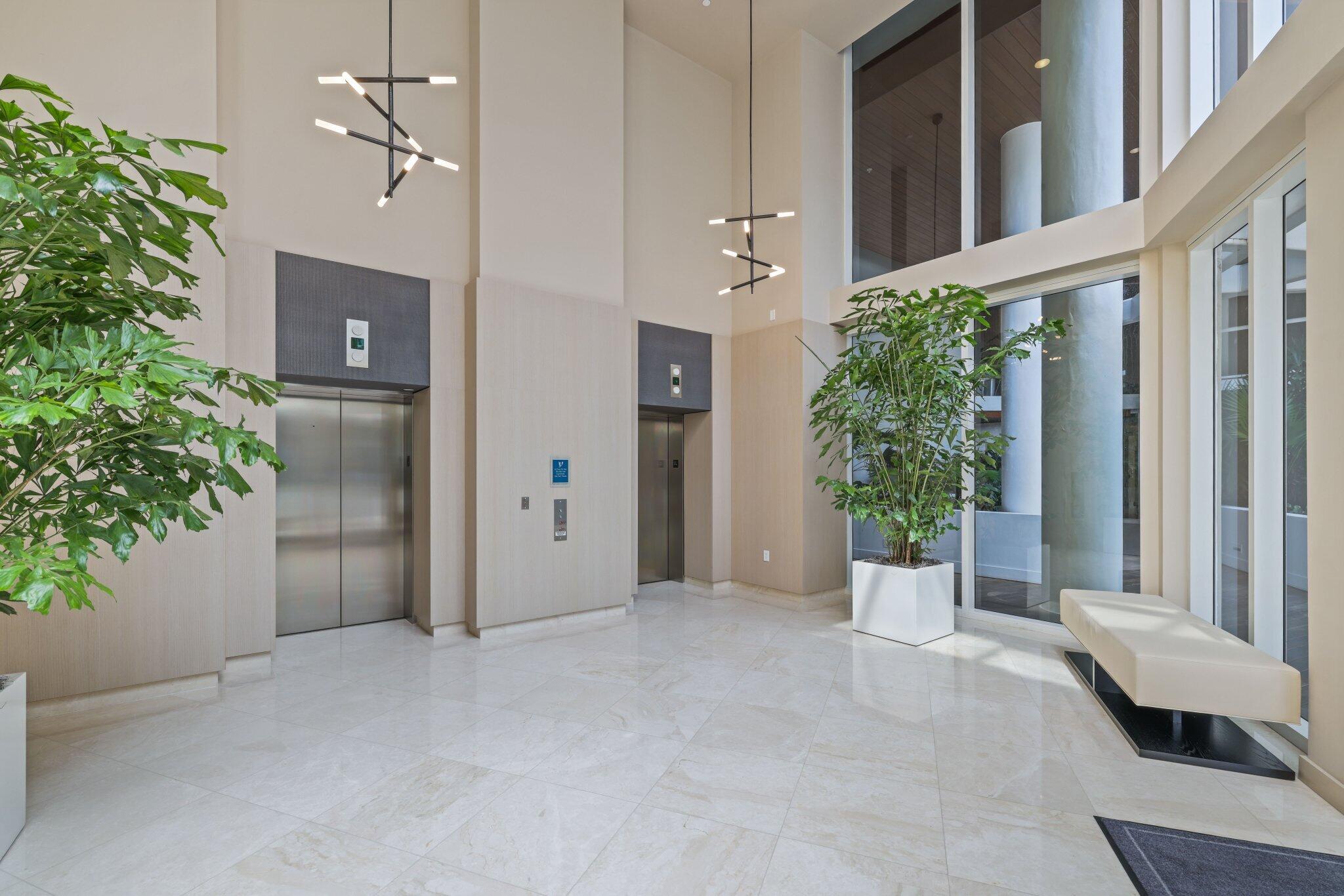 1000 South Ocean Boulevard, Unit 309 Boca Raton, FL 33432 - Photo 40 of 63 a view of an entryway with a flower plants and wooden fence