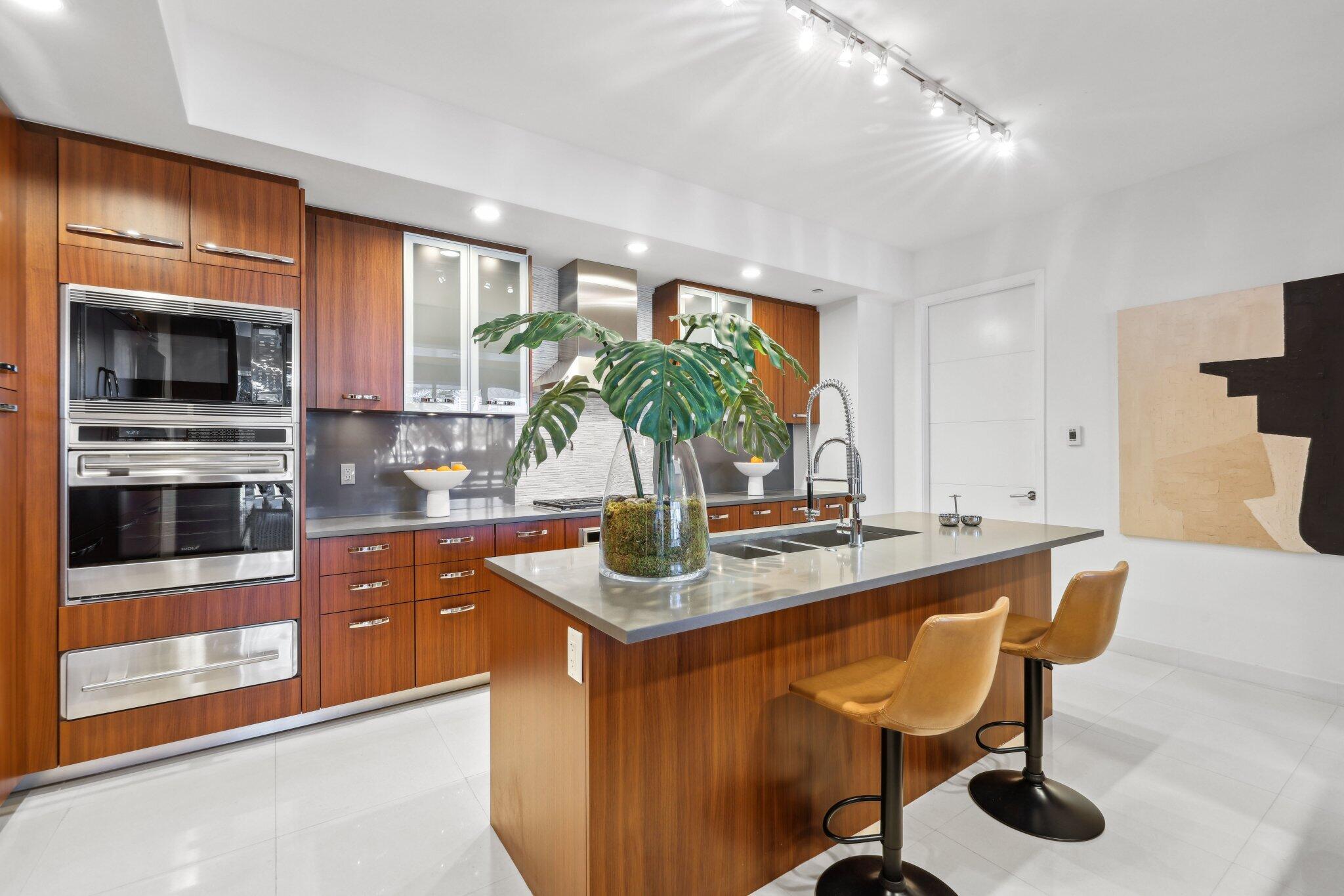 1000 South Ocean Boulevard, Unit 309 Boca Raton, FL 33432 - Photo 57 of 63 a kitchen with stainless steel appliances granite countertop a sink and a refrigerator