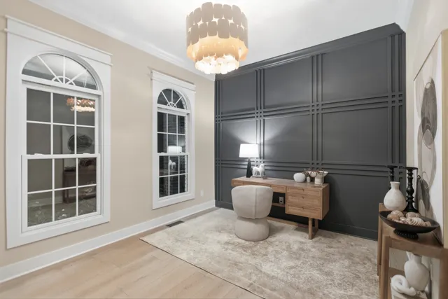 a living room with furniture a chandelier and a fireplace