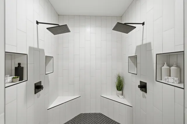 a bathroom with a double vanity sink and mirror with bathtub
