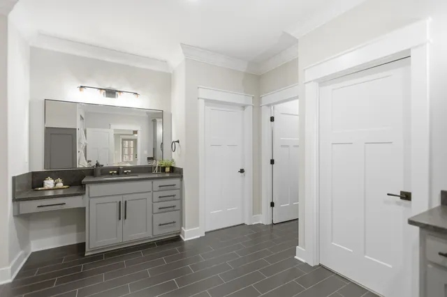 a bathroom with a granite countertop toilet a sink and shower