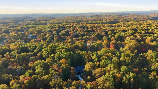 a view of a house with a small yard and floor to ceiling window