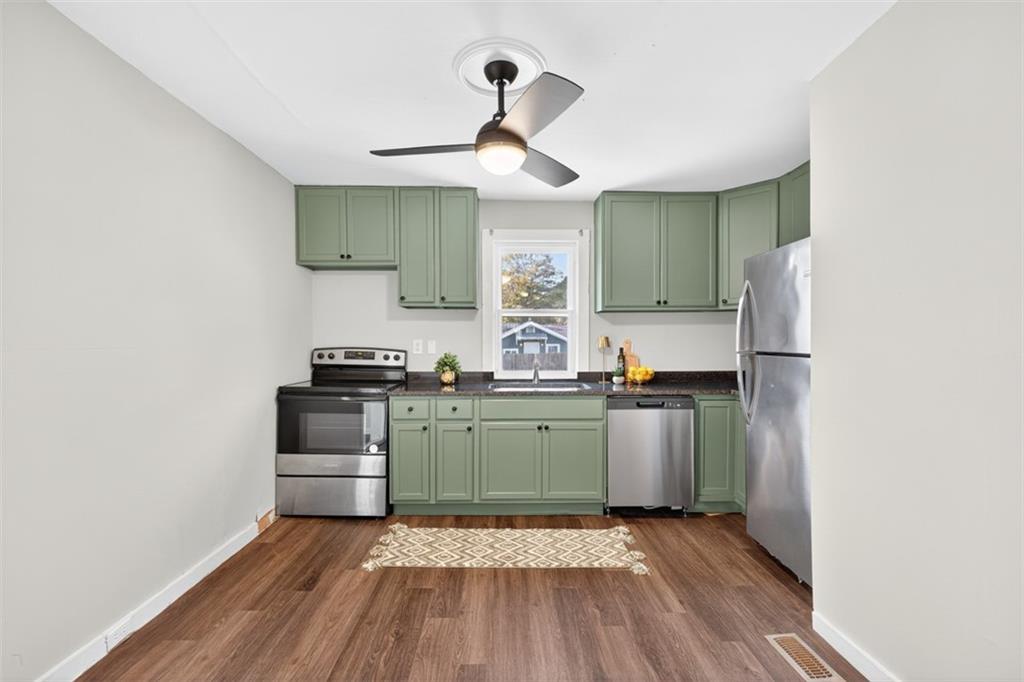 132 Victory Drive Monroe, GA 30655 - Photo 11 of 36 a kitchen with stainless steel appliances granite countertop a stove and a refrigerator