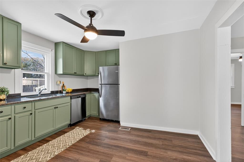 132 Victory Drive Monroe, GA 30655 - Photo 14 of 36 a kitchen with stainless steel appliances granite countertop a sink and a refrigerator
