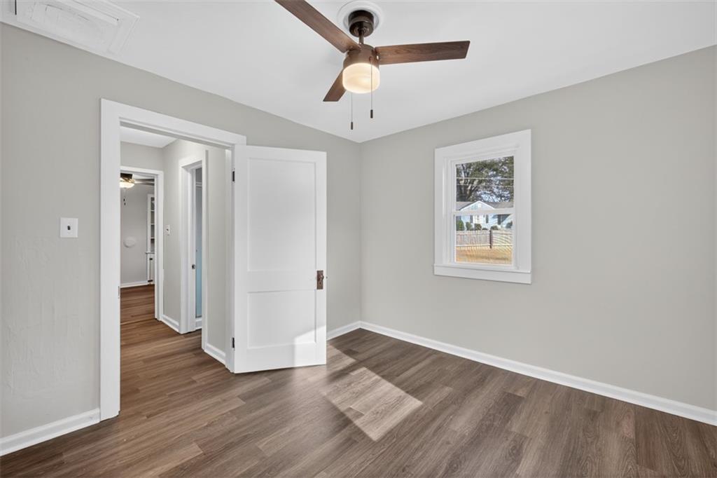 132 Victory Drive Monroe, GA 30655 - Photo 22 of 36 an empty room with wooden floor and ceiling fan