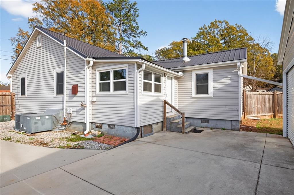 132 Victory Drive Monroe, GA 30655 - Photo 26 of 36 a view of a house with a small yard and wooden fence