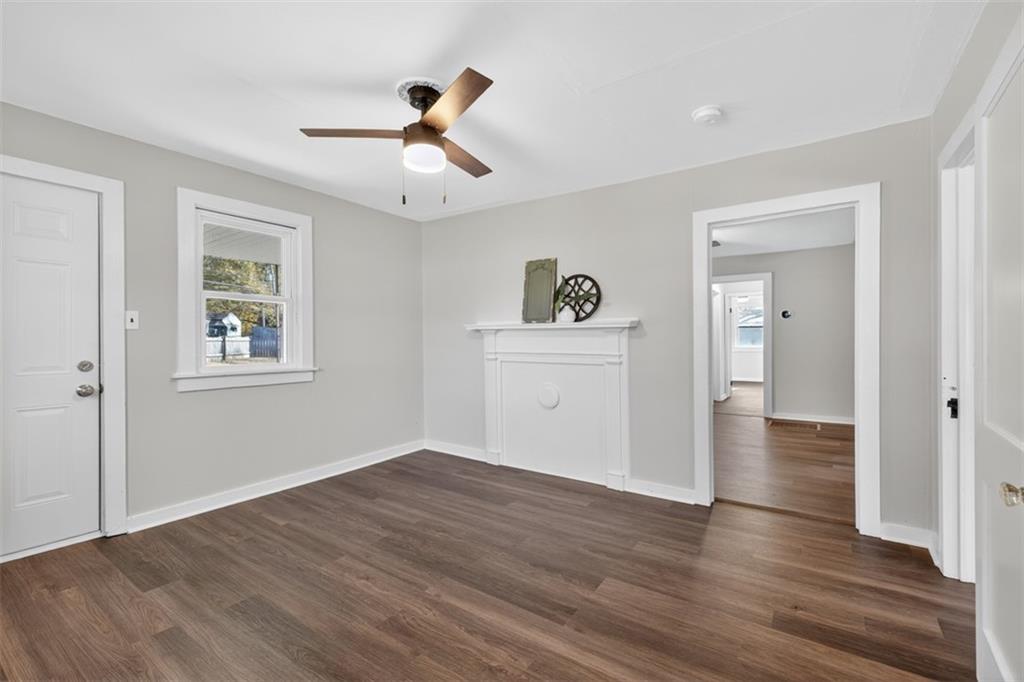 132 Victory Drive Monroe, GA 30655 - Photo 6 of 36 a view of empty room with wooden floor and ceiling fan