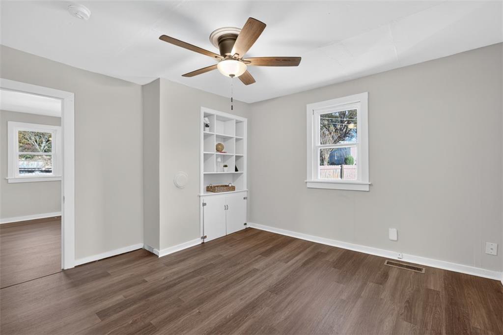 132 Victory Drive Monroe, GA 30655 - Photo 9 of 36 a view of a livingroom with a hardwood floor and a ceiling fan