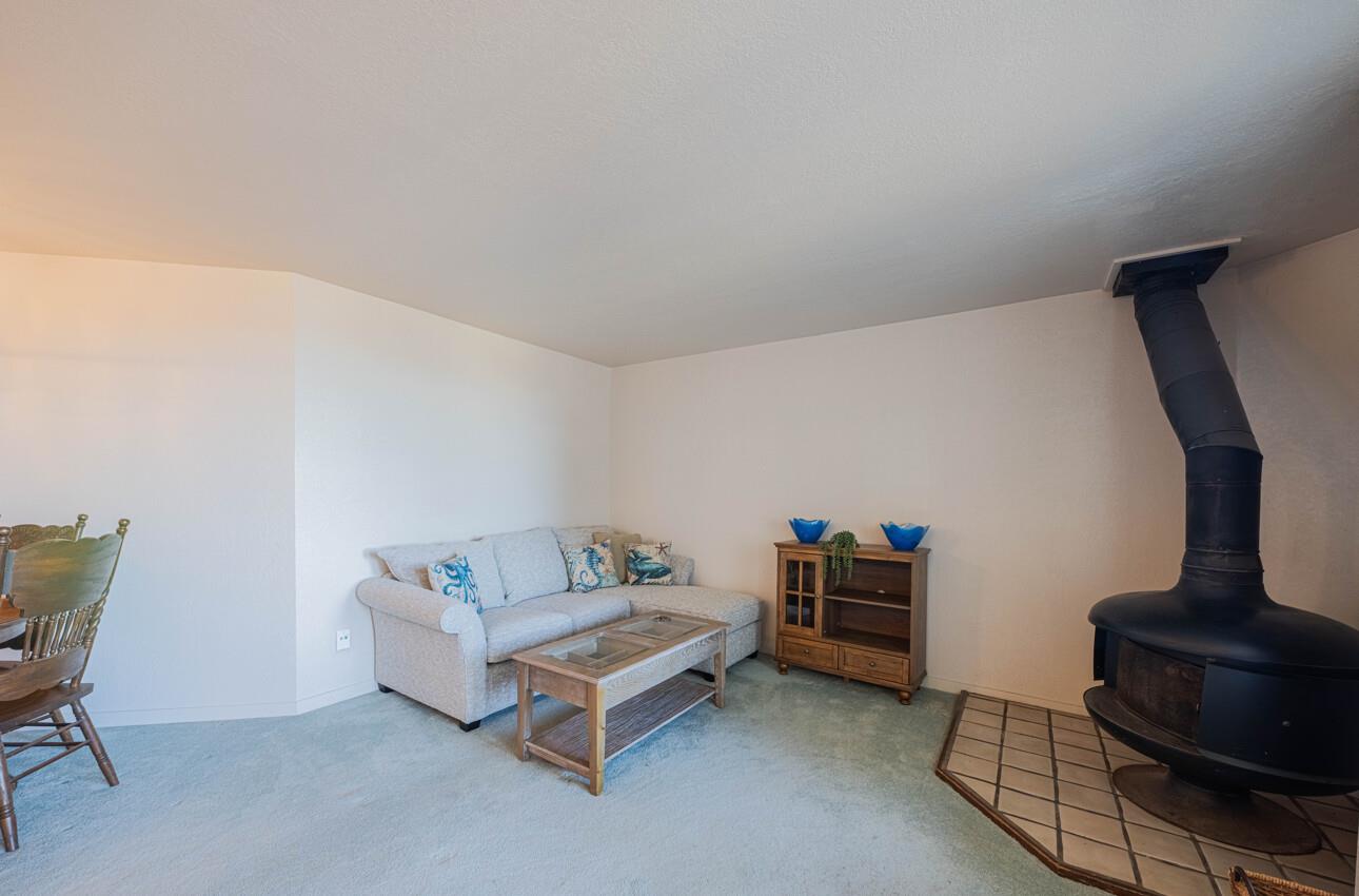 585 Hawthorne Street, Unit 103 Monterey, CA 93940 - Photo 10 of 30 a living room with furniture and a lamp