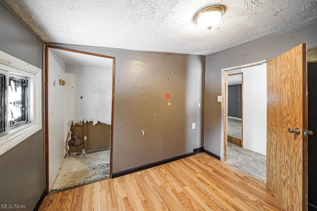 9606 Durst Colebrook Road North Bloomfield, OH 44450 - Photo 9 of 24 Empty room with light carpet and a textured ceiling