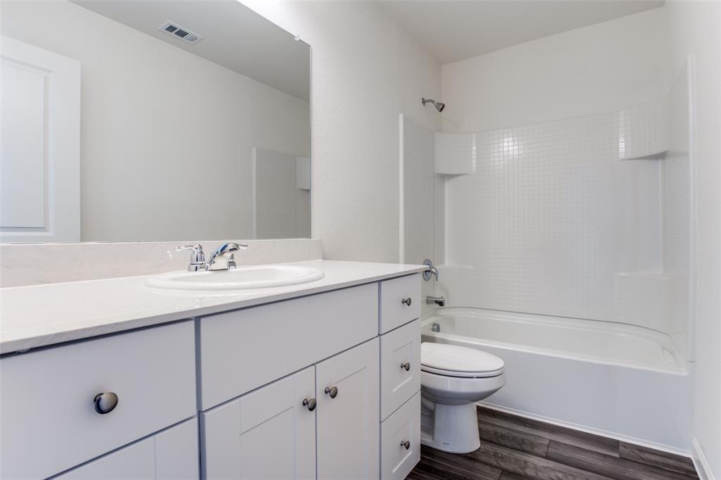 622 Colgate Circle Princeton, TX 75407 - Photo 8 of 12 Bathroom featuring bathtub / shower combination, vanity, and dark wood-style flooring
