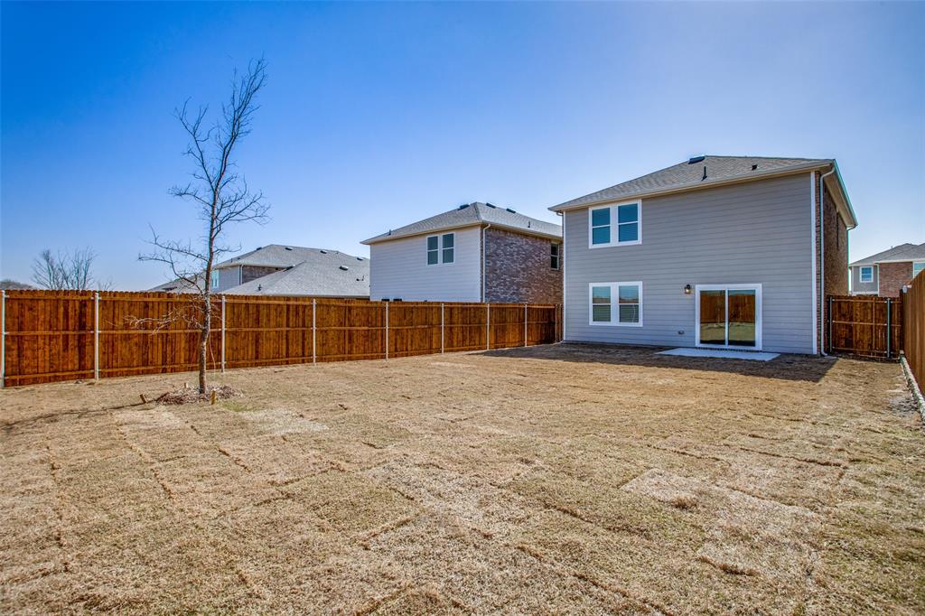 622 Colgate Circle Princeton, TX 75407 - Photo 9 of 12 Rear view of house with a fenced backyard and a patio
