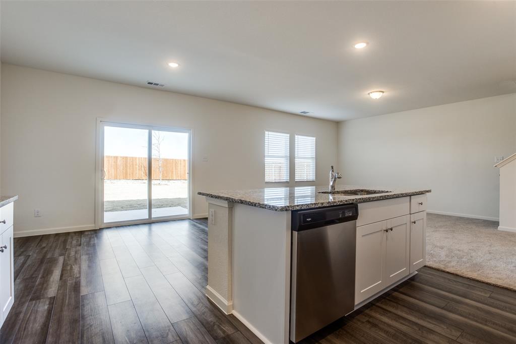 622 Colgate Circle Princeton, TX 75407 - Photo 2 of 12 Kitchen with white cabinets, dishwasher, dark stone counters, dark wood-style floors, and recessed lighting