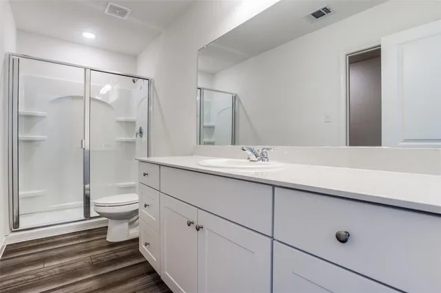 a view of kitchen with kitchen island white cabinets and stainless steel appliances