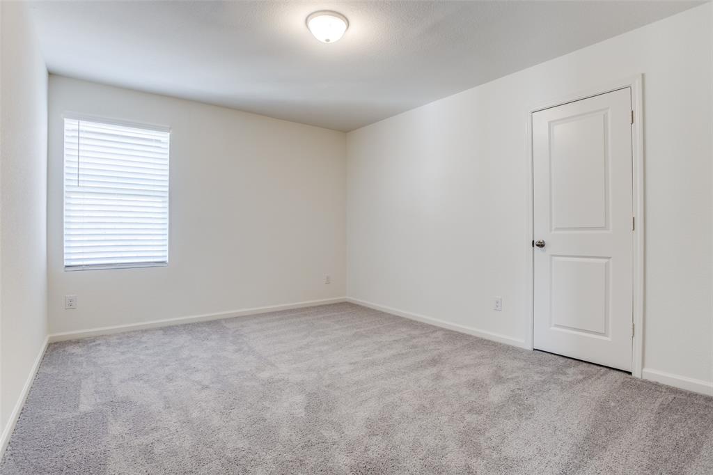 622 Colgate Circle Princeton, TX 75407 - Photo 6 of 12 Bedroom featuring light colored carpet and baseboards