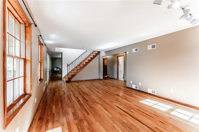 a view of an entryway with wooden floor